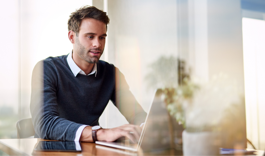 Young businessman using a laptop while working from home